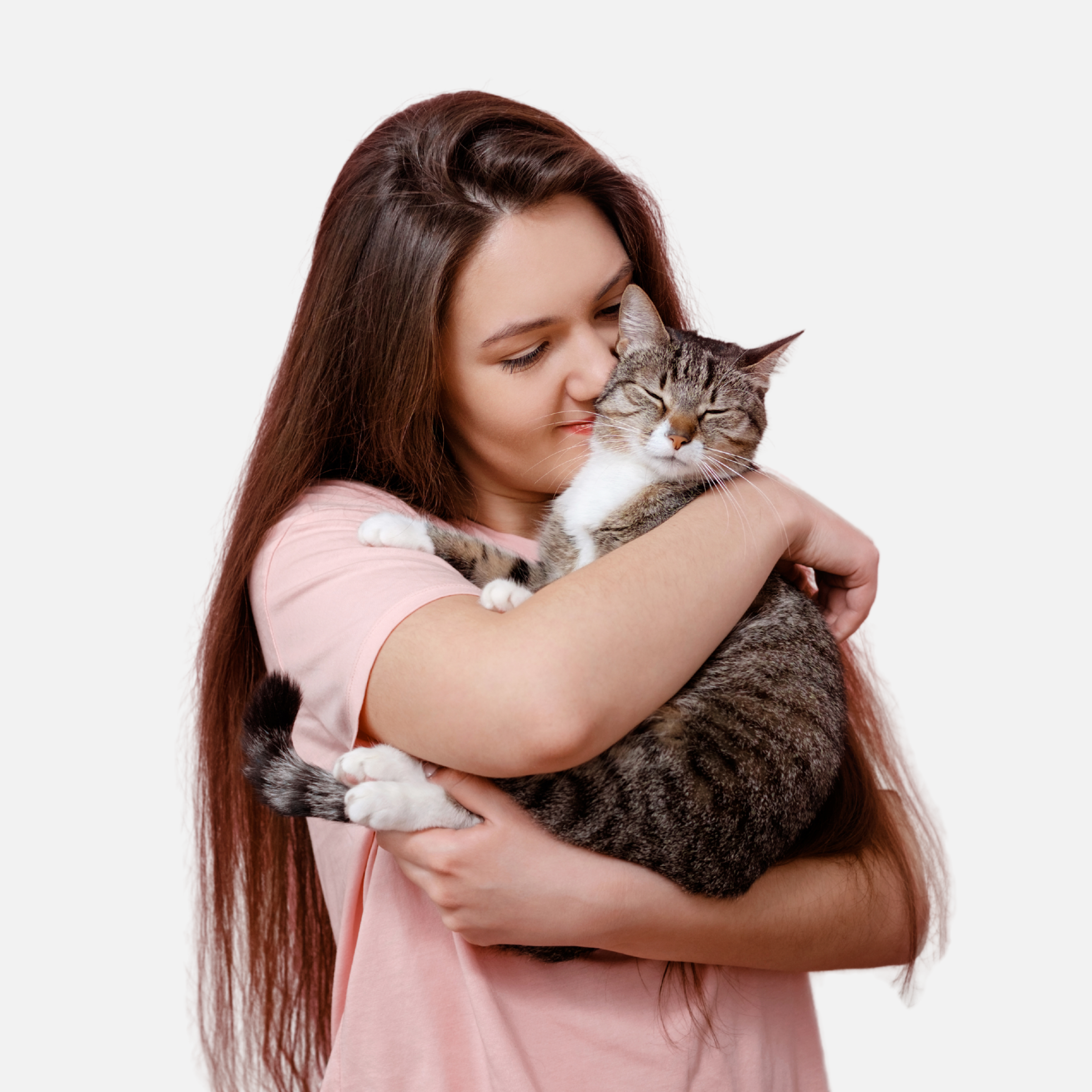 A smiling woman in a pink shirt lovingly hugging her content tabby cat, showcasing the bond between pets and their owners.